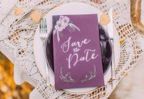 Lovely purple postcard on the plate with lace towels close up